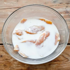 Chicken breasts soaking in buttermilk brine for hot honey chicken sandwich.