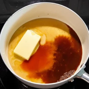 Butter and honey mixture melting in saucepan