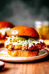 Crispy hot honey chicken sandwich stacked with slaw and pickles