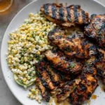 Hot Honey Grilled Chicken with corn salad and lime wedges