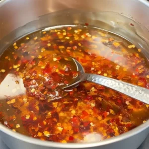 Hot Honey Chicken Tenders 9 Homemade hot honey sauce simmering with chili flakes