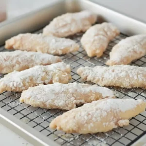 Hot Honey Chicken Tenders 7 Breaded chicken tenders resting before frying